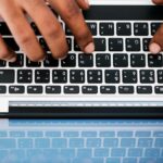 Top view of man using computer laptop at work