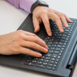 Top view of man typing on keyboard