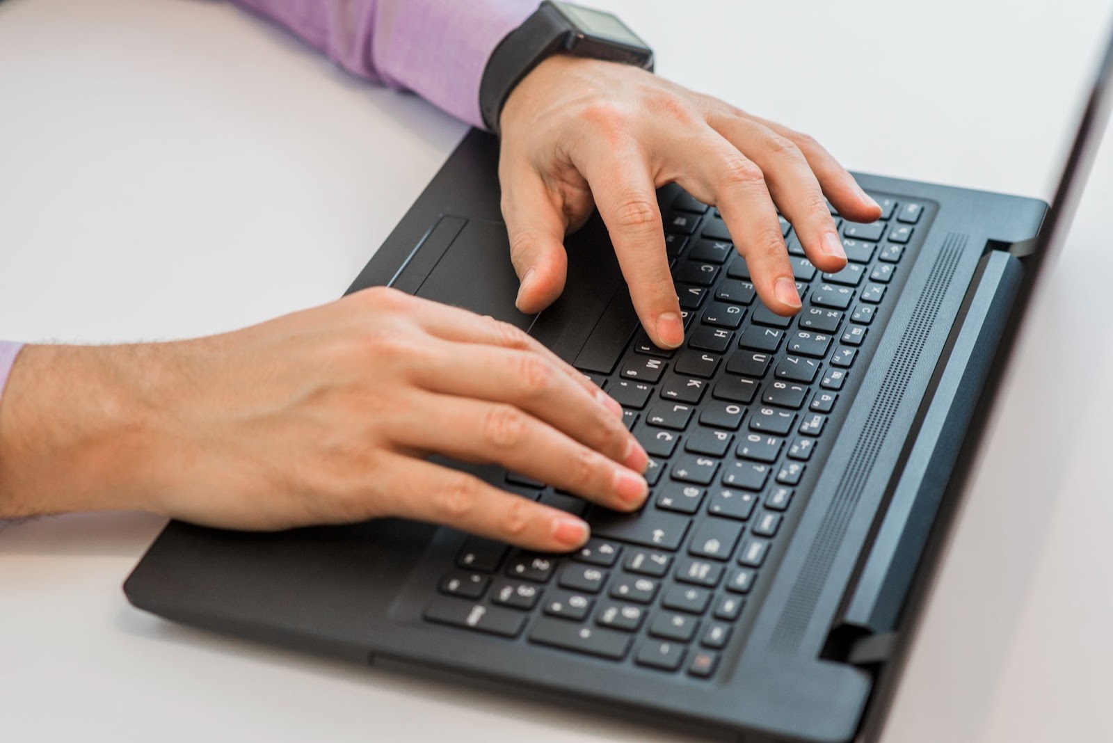 Top view of man typing on keyboard