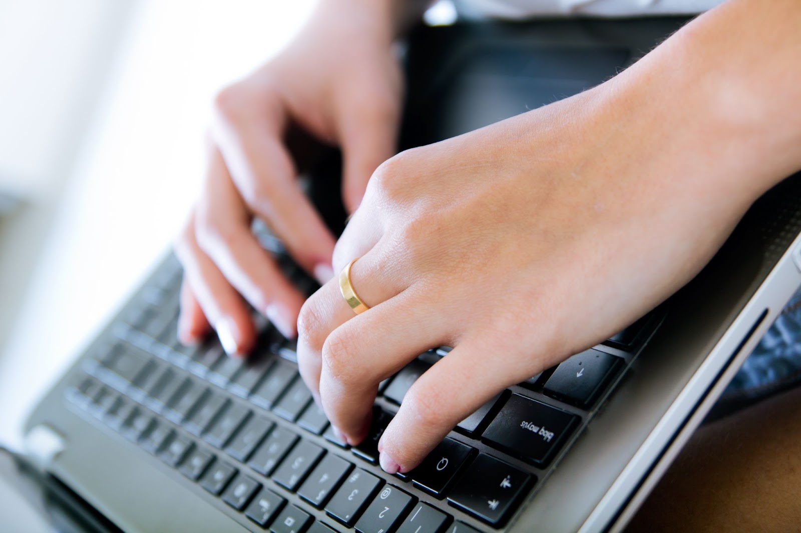 Close up of woman typing on keyboard