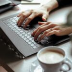 Man's hands typing on a keyboard